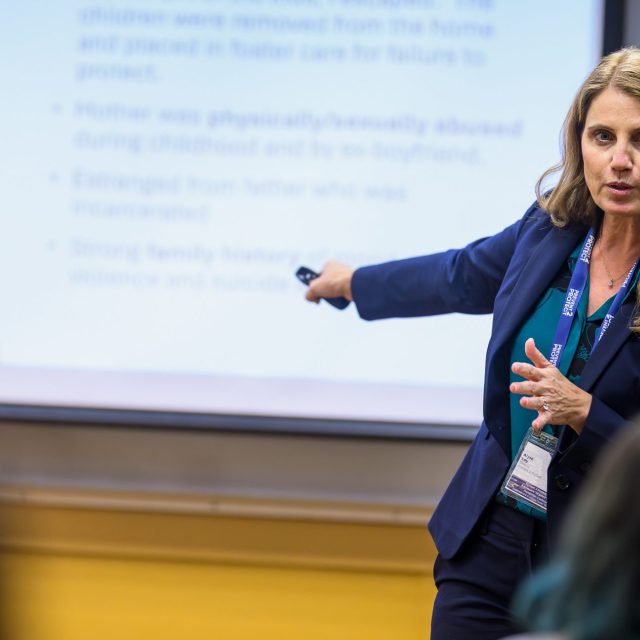 A picture of Dr. Alyse Folino Ley presenting at a conference.