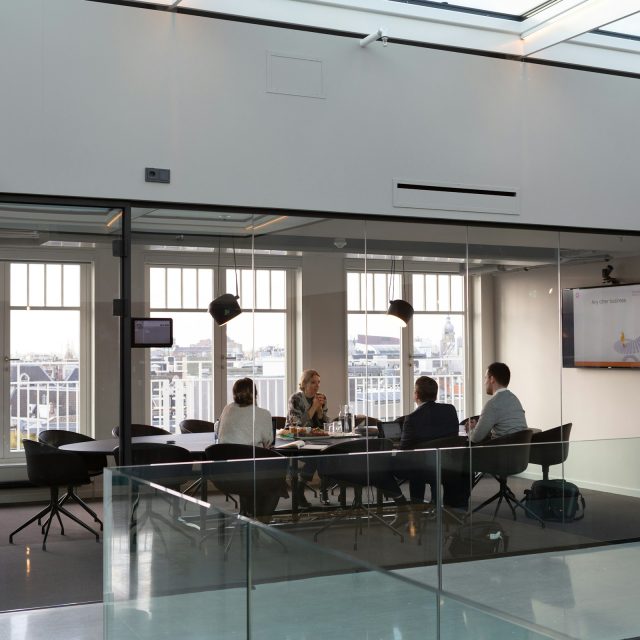 A group of people meeting in a conference room